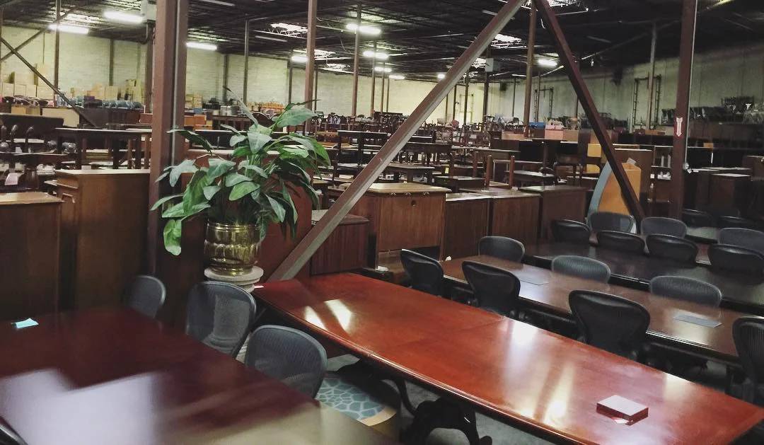 Used office wooden furniture Collection stored in a warehouse in Houston, Texas