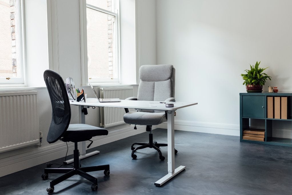 Two office seating chairs with a table setup for work in Houston, TX