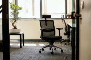 A black office chair sits in a Houston, TX, office, creating a welcoming work environment.